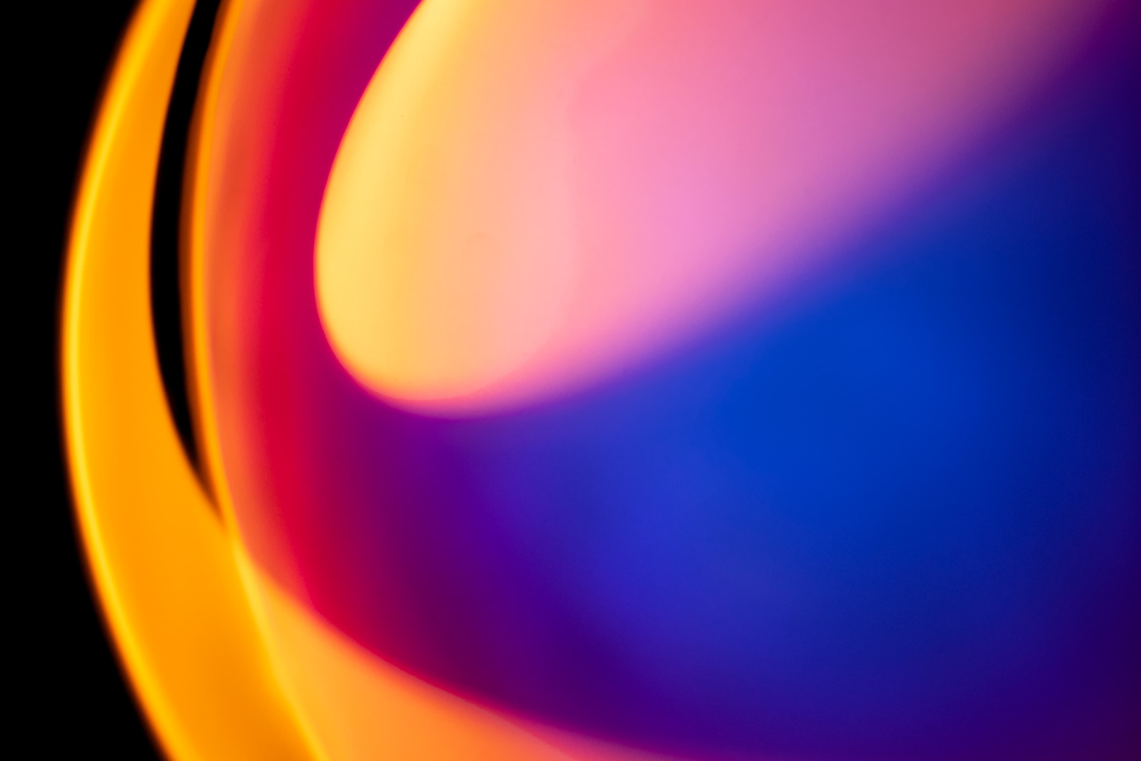 Abstract neon background with orange, pink, and blue light